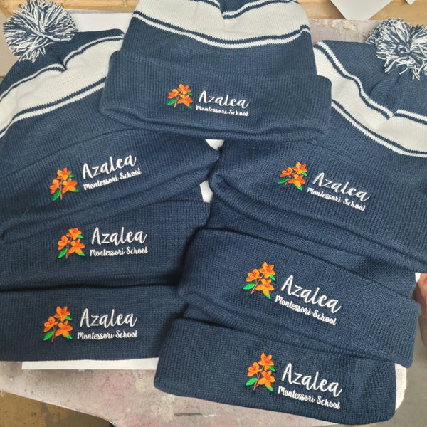 Embroidered pom beanies for Norwood-based Azalea Montessori School